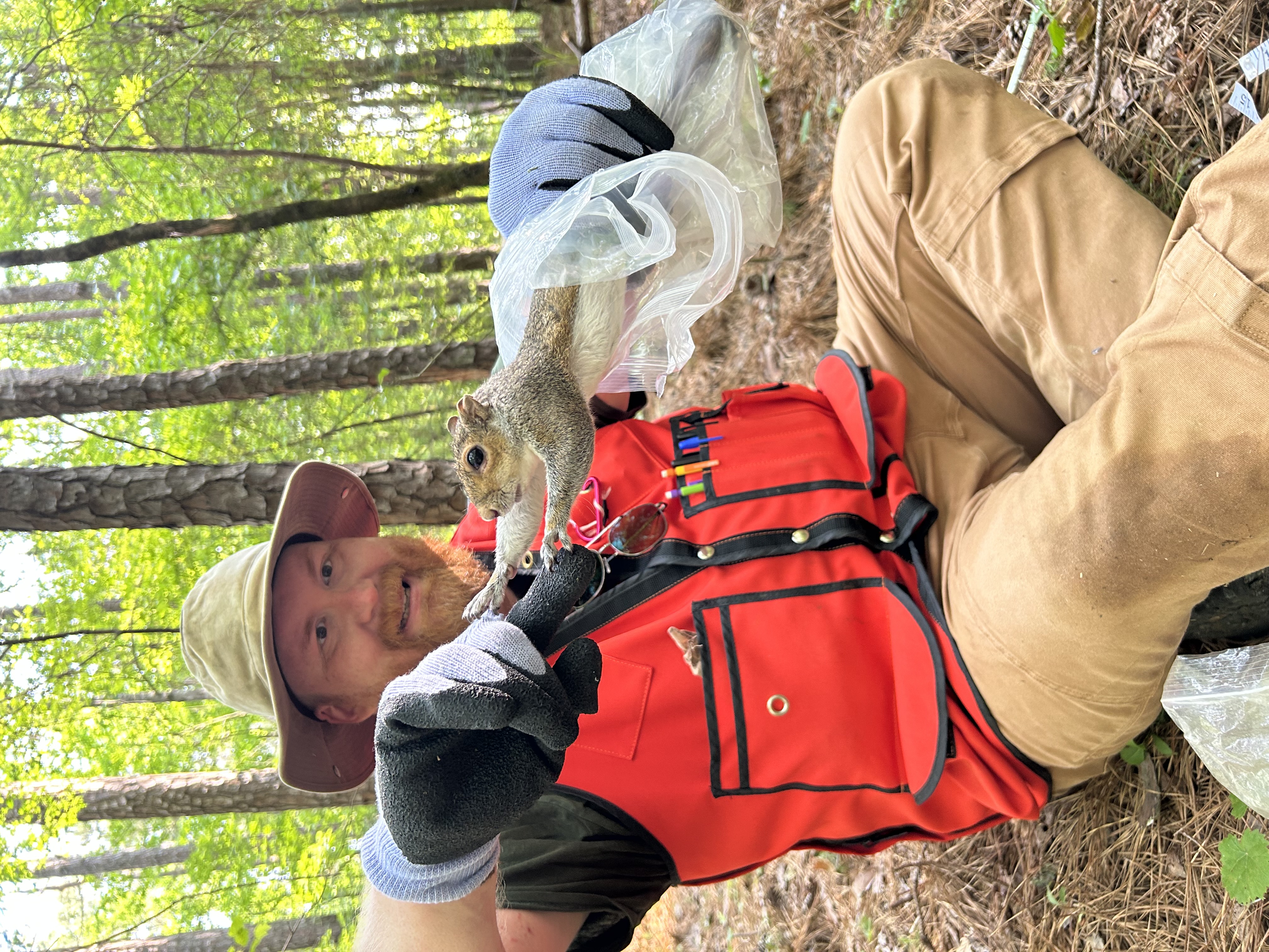 Portrait or field photograph of Nick Green holding a squirrel.