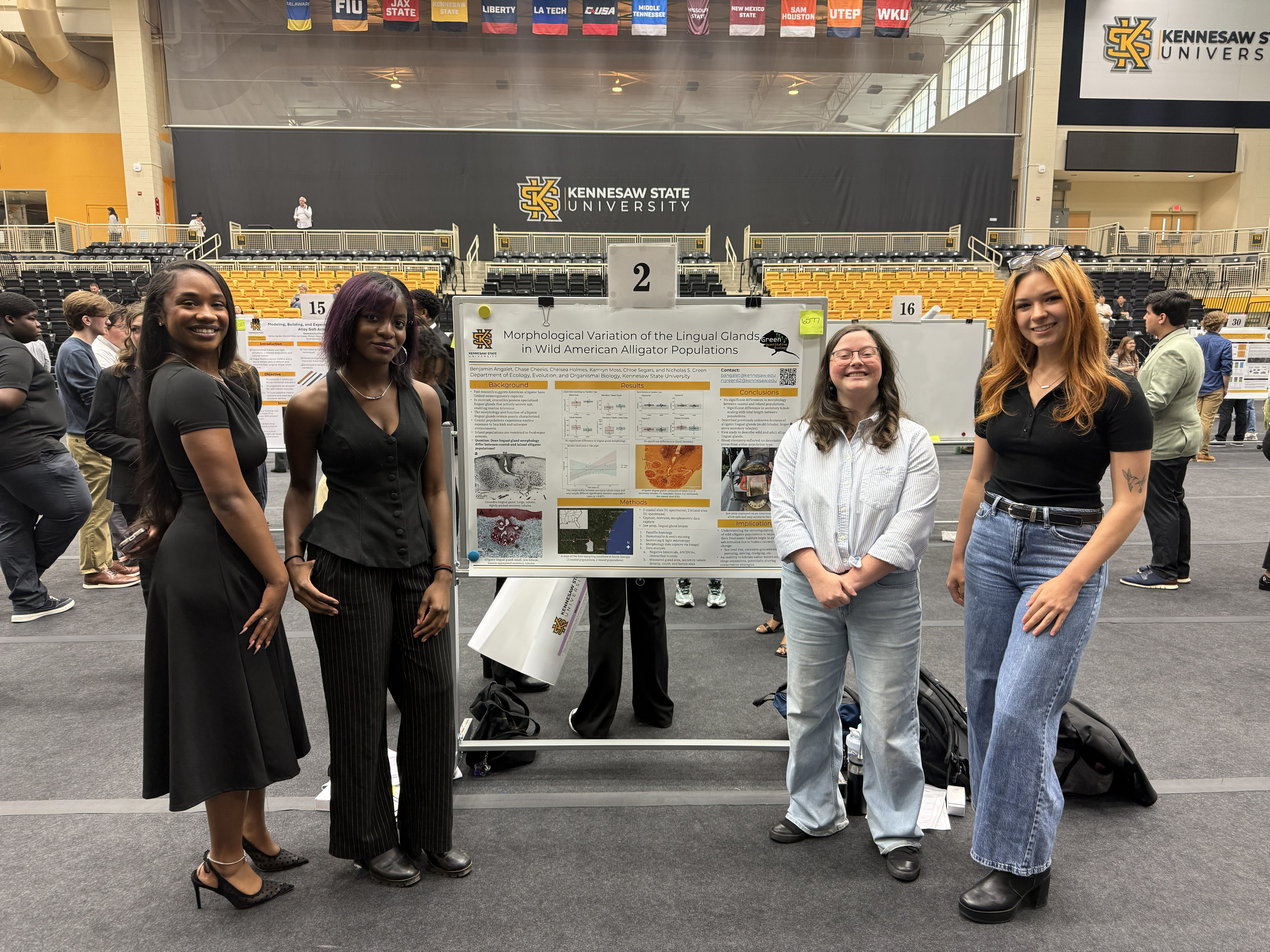 Four students standing with a research poster.